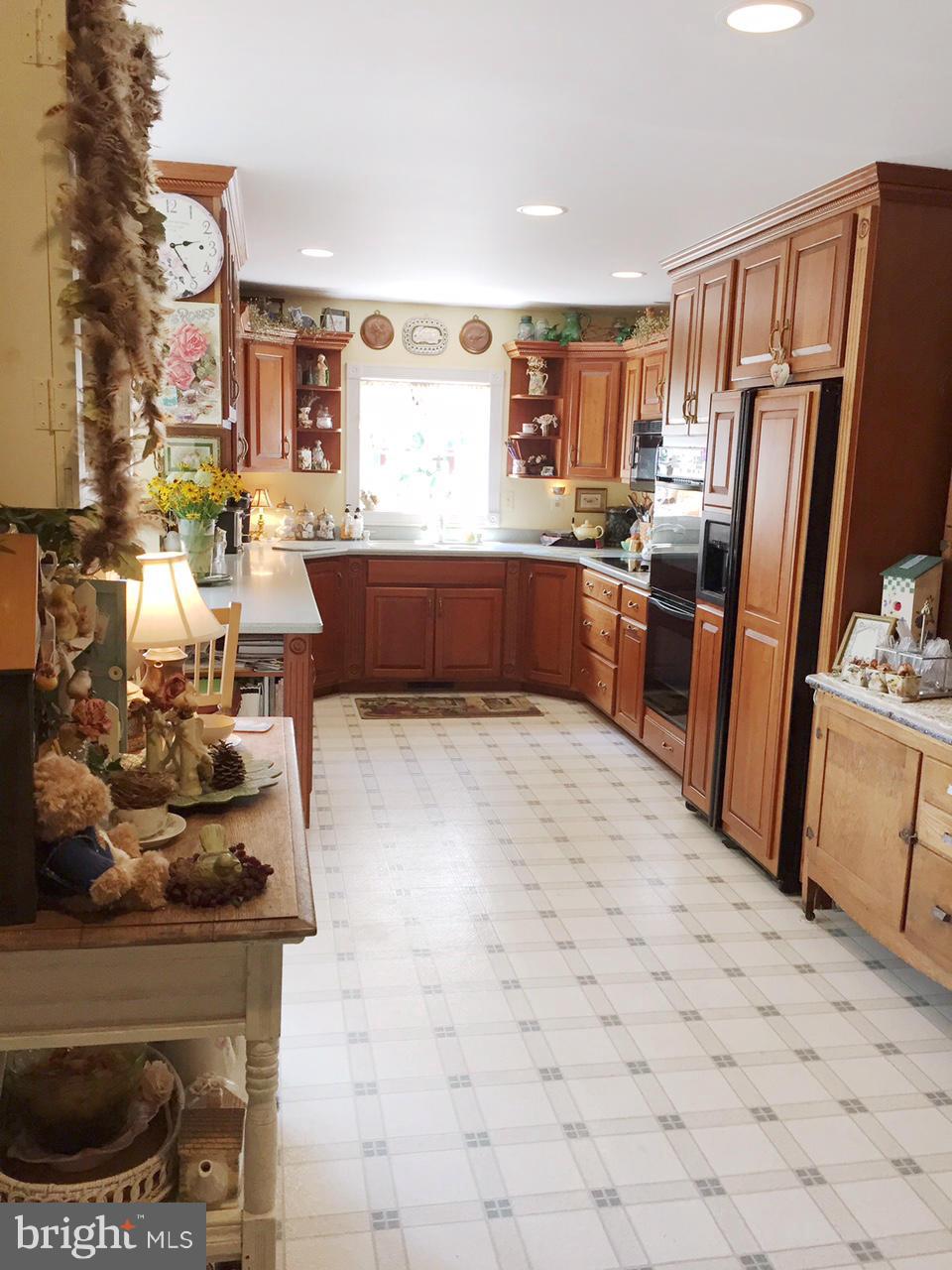 5407 Sumerduck Road Sumerduck, VA 22742 - Photo 20 of 30 a kitchen with stainless steel appliances kitchen island granite countertop a refrigerator stove and sink