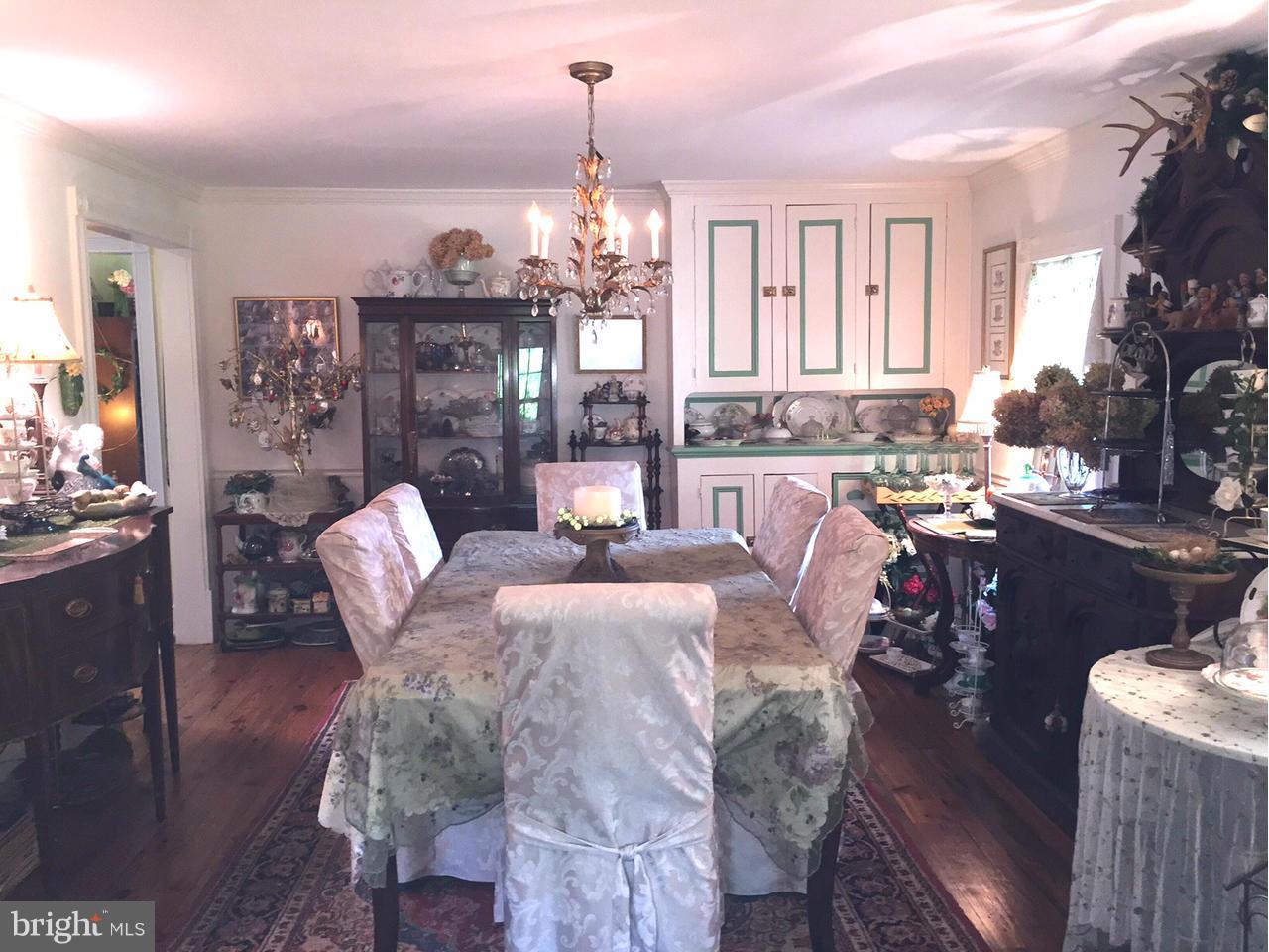 5407 Sumerduck Road Sumerduck, VA 22742 - Photo 21 of 30 a view of a dining room with furniture a chandelier and wooden floor