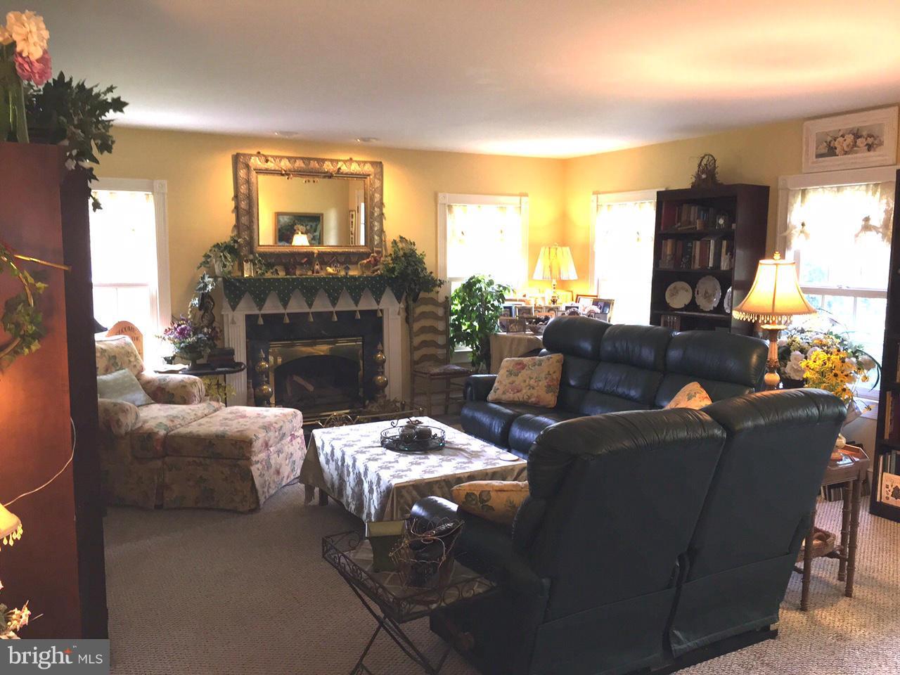 5407 Sumerduck Road Sumerduck, VA 22742 - Photo 22 of 30 a living room with furniture a fireplace and a large window