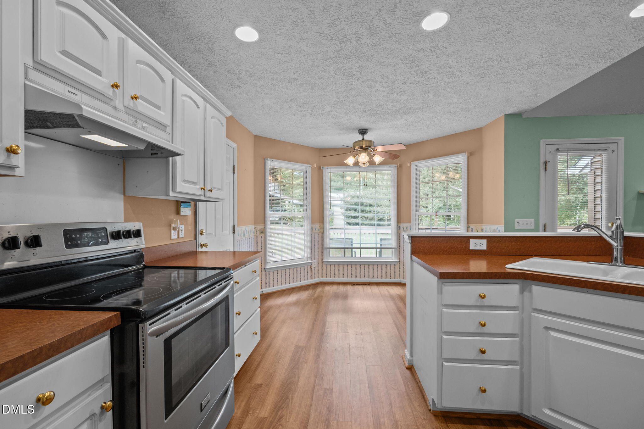 25 Poplar Lane Roxboro, NC 27574 - Photo 25 of 41 a kitchen with granite countertop white cabinets and white appliances