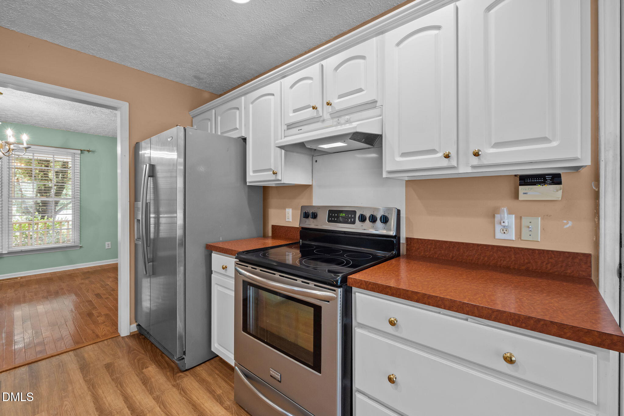 25 Poplar Lane Roxboro, NC 27574 - Photo 28 of 41 a kitchen with white cabinets and appliances