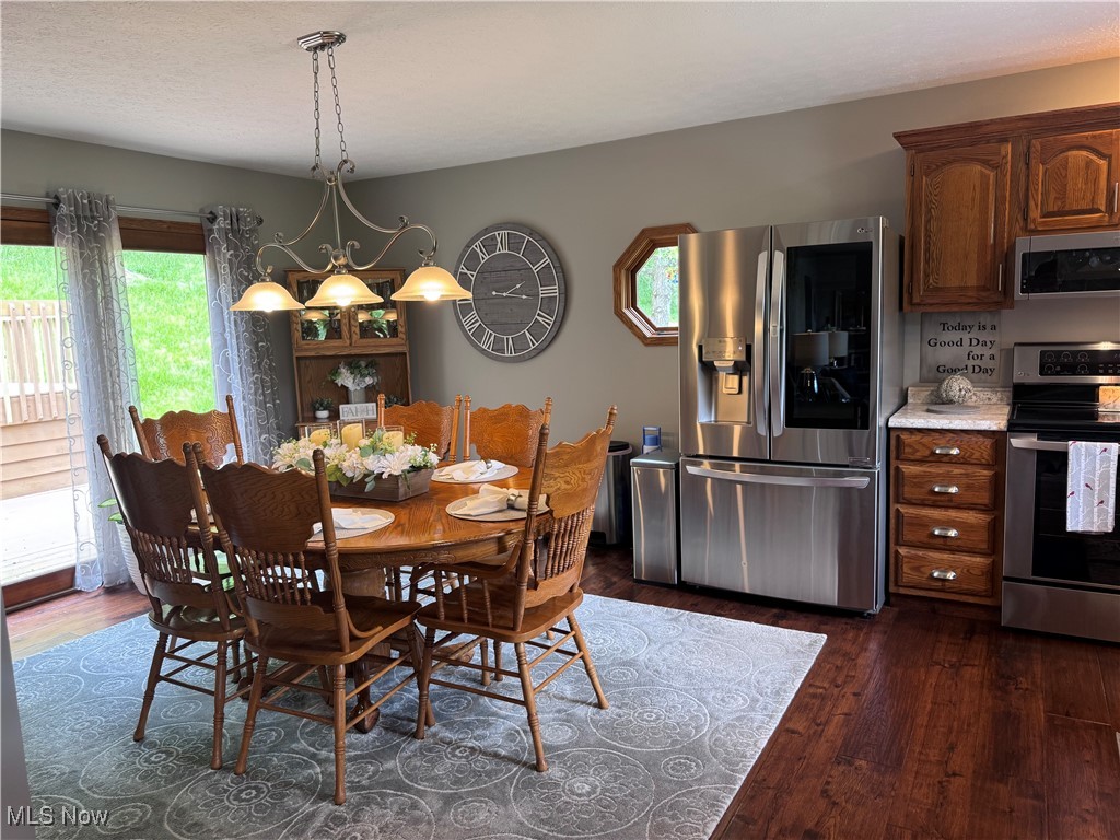 631 Short Brook Road Vincent, OH 45784 - Photo 14 of 31 Dining space with dark wood finished floors and a chandelier
