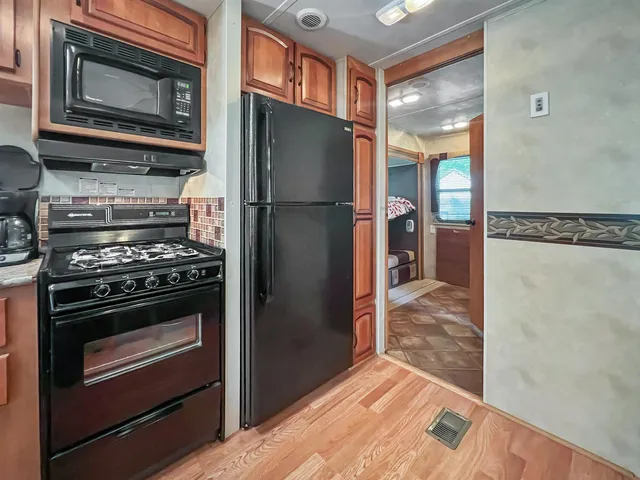 a bathroom with a sink a toilet a mirror and shower