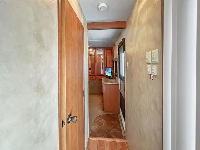 a bedroom with a bed a flat screen tv and balcony view