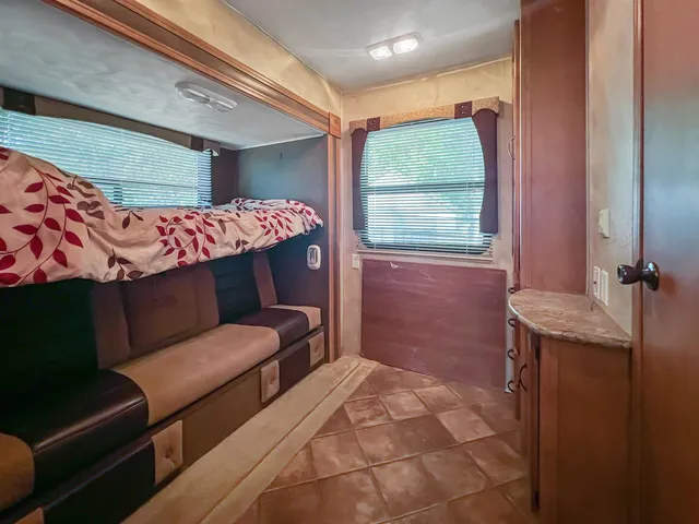a bathroom with a toilet sink vanity and mirror