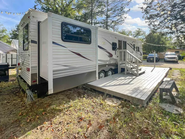 a view of a small house with a yard