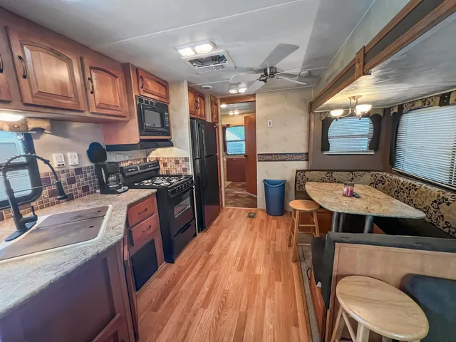 a kitchen with stainless steel appliances granite countertop a stove and a microwave