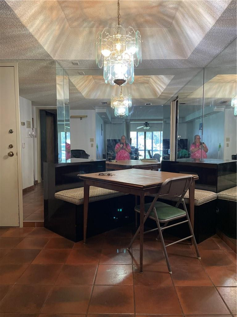 3760 Inverrary Drive, Unit N 1Y Lauderhill, FL 33319 - Photo 28 of 28 a room with a dining table wooden floor and a chandelier