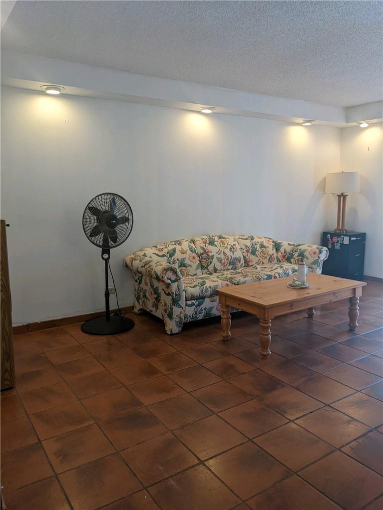 3760 Inverrary Drive, Unit N 1Y Lauderhill, FL 33319 - Photo 3 of 28 a bedroom with a bed and a chandelier