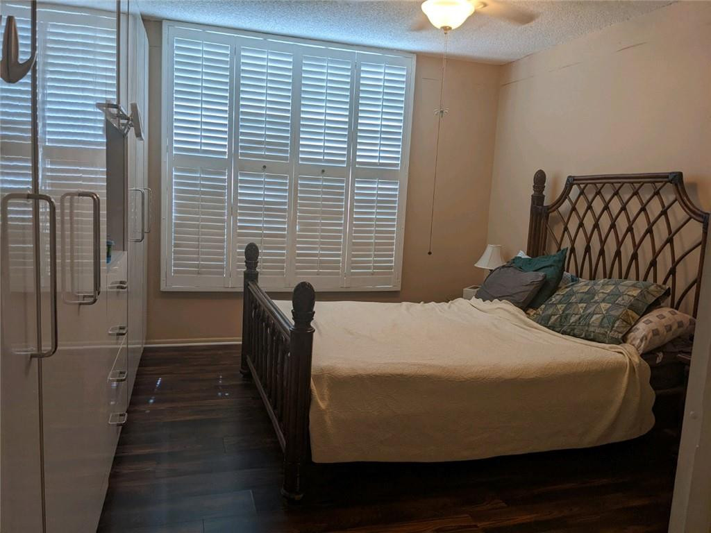 3760 Inverrary Drive, Unit N 1Y Lauderhill, FL 33319 - Photo 4 of 28 a bedroom with a bed and wooden floor