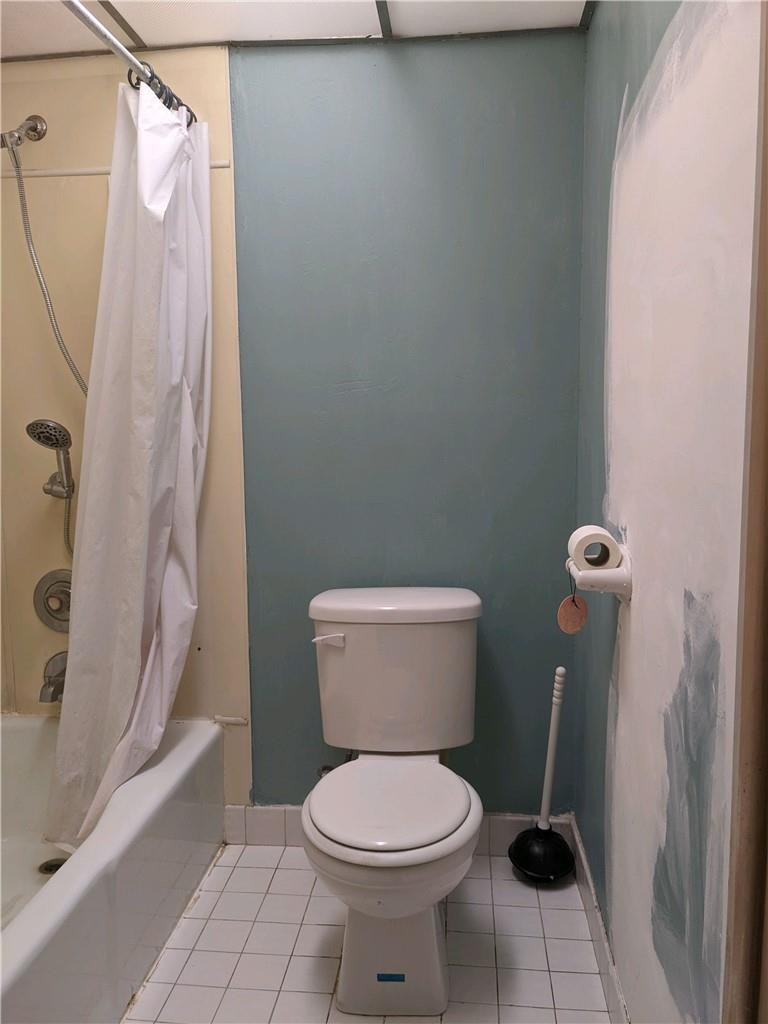 3760 Inverrary Drive, Unit N 1Y Lauderhill, FL 33319 - Photo 8 of 28 a white toilet sitting next to a bath tub and a shower
