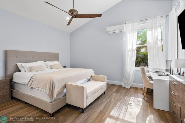 a bed room with a bed and a chair