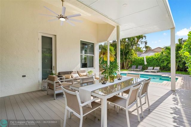 a view of a patio with a dining table and chairs