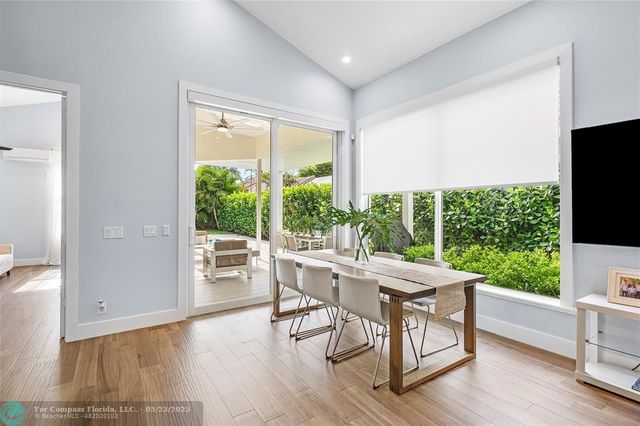 a dining room with furniture window and wooden floor