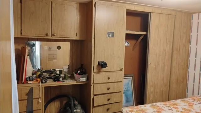 a view of a dresser and storage space