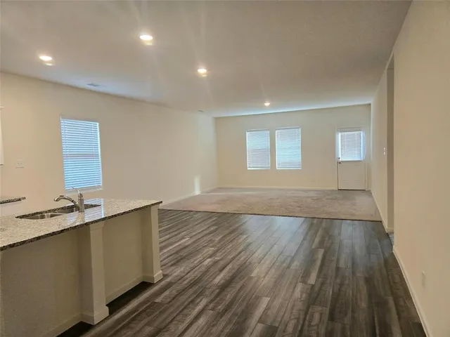 an aerial view of a house with a garden and lake view