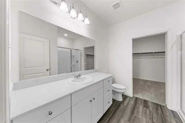 a front view of a house with a garden and plants