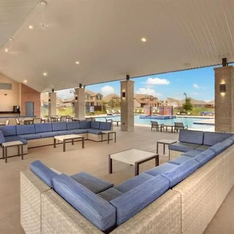 a view of a swimming pool with an outdoor seating