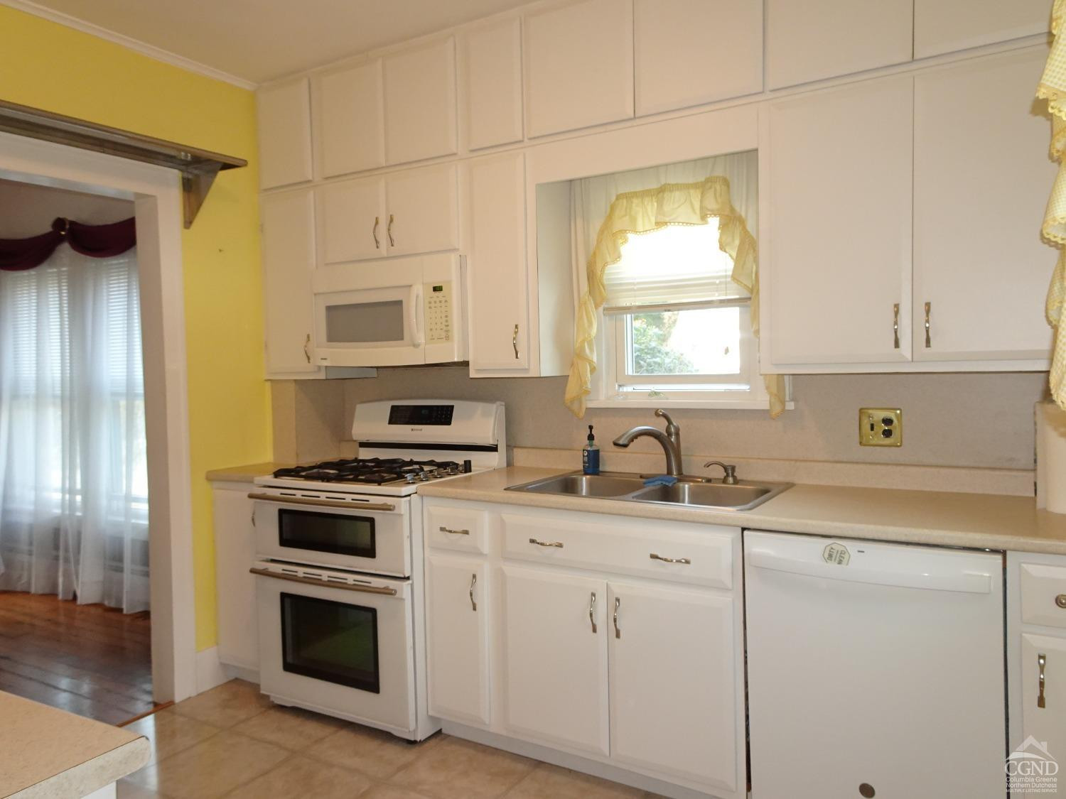 161 Highway 23 Claverack, NY 12513 - Photo 16 of 56 a kitchen with granite countertop white cabinets and white appliances