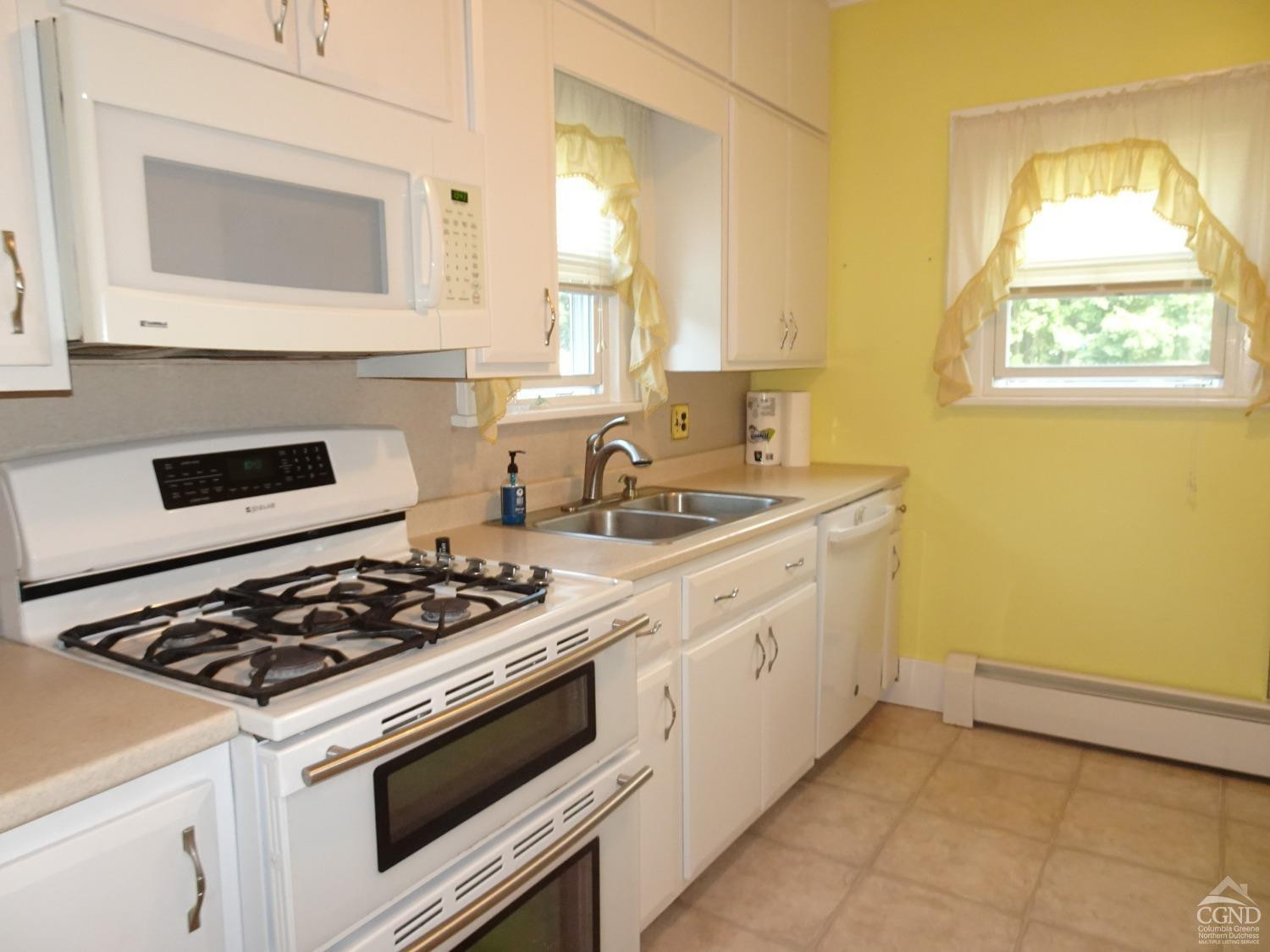 161 Highway 23 Claverack, NY 12513 - Photo 17 of 56 a kitchen with stainless steel appliances a stove and white cabinets