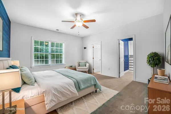 a bedroom with a large bed and a window