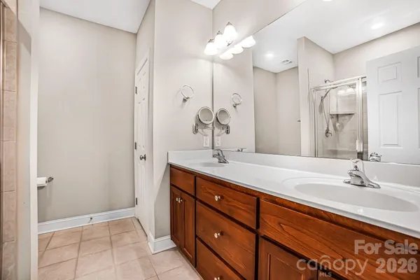 a bathroom with a double vanity sink and a mirror