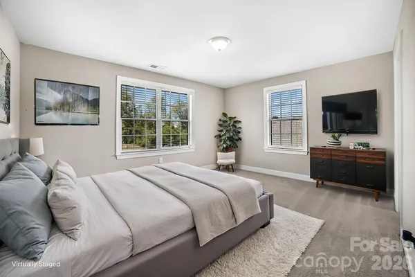 a bedroom with a bed and a tv