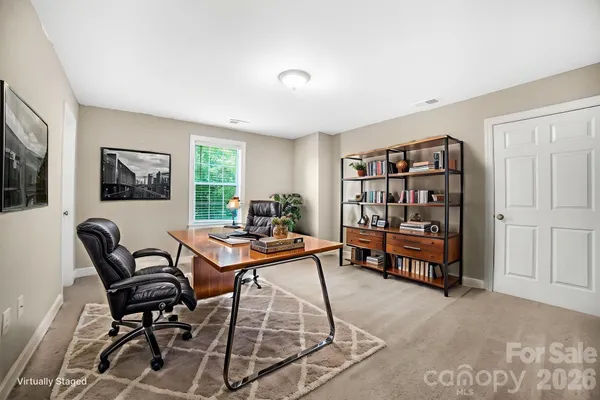 a living room with furniture a rug and a window