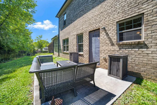 a view of a patio with a table and chairs