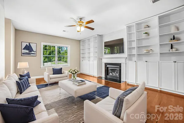 a living room with furniture a flat screen tv and a fireplace