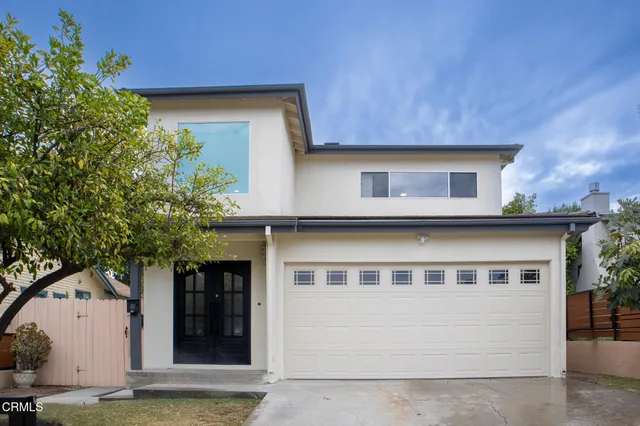 a front view of a house with a garage