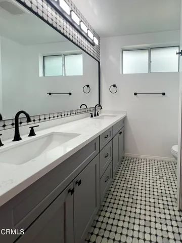 a spacious bathroom with a sink and a mirror