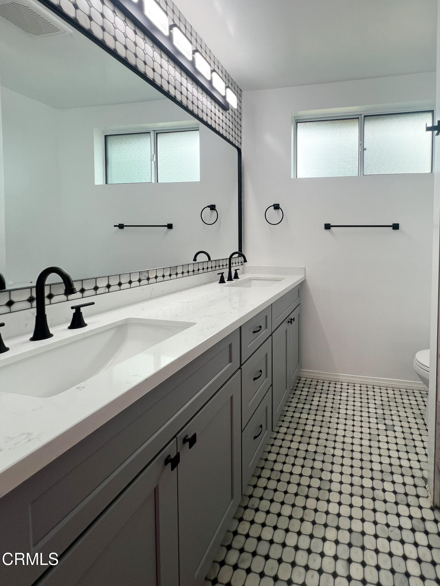 5246 Hub Street Los Angeles, CA 90042 - Photo 11 of 12 a spacious bathroom with a sink and a mirror
