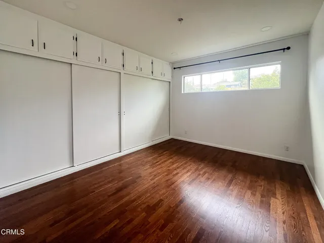 an empty room with wooden floor