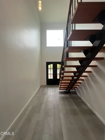 an empty room with windows and stairs