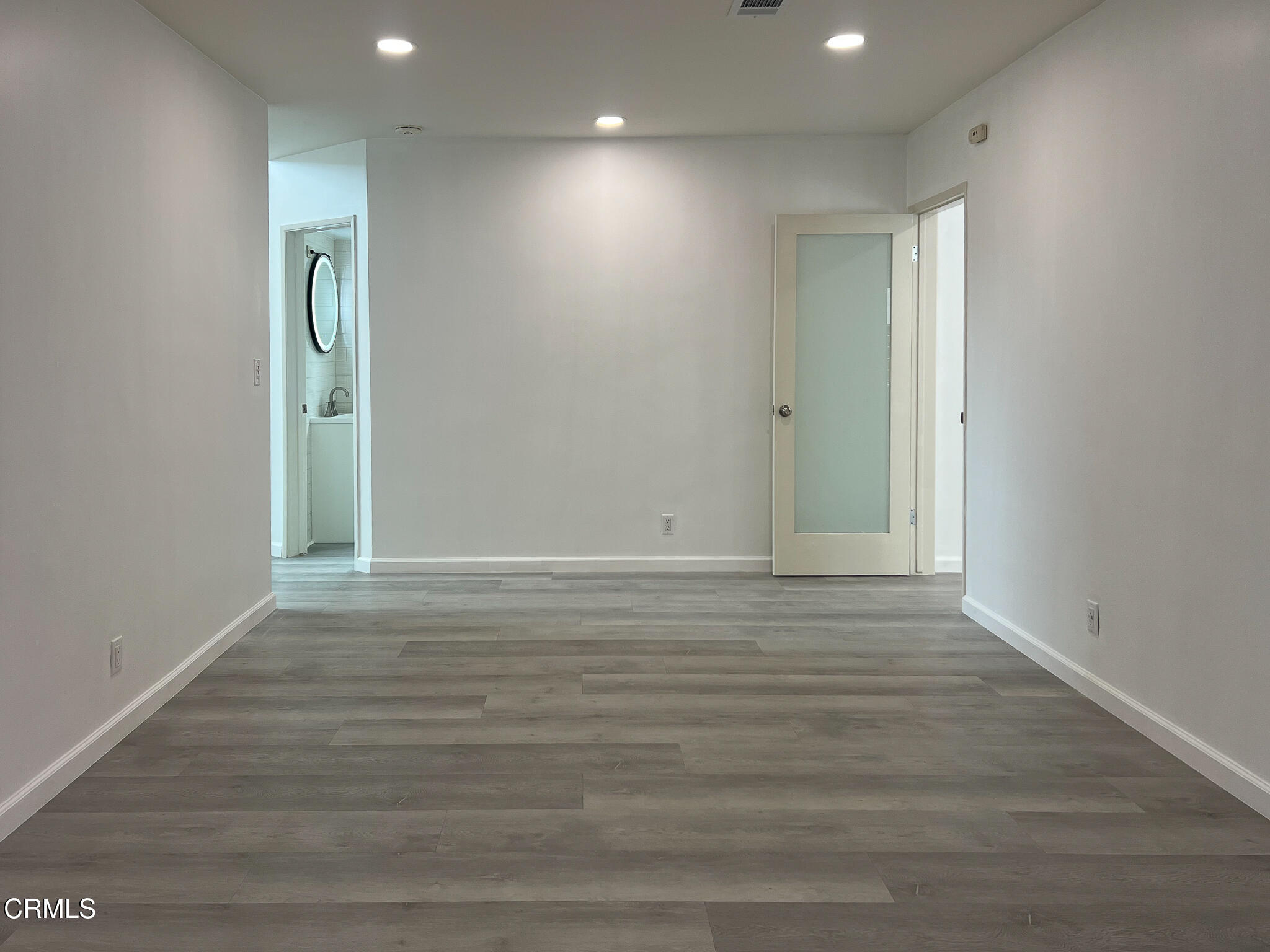 5246 Hub Street Los Angeles, CA 90042 - Photo 9 of 12 an empty room with wooden floor and mirror