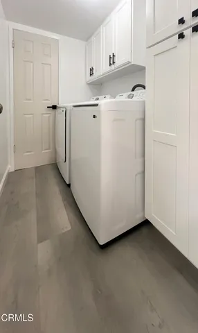 a view of a kitchen with closet and white cabinets
