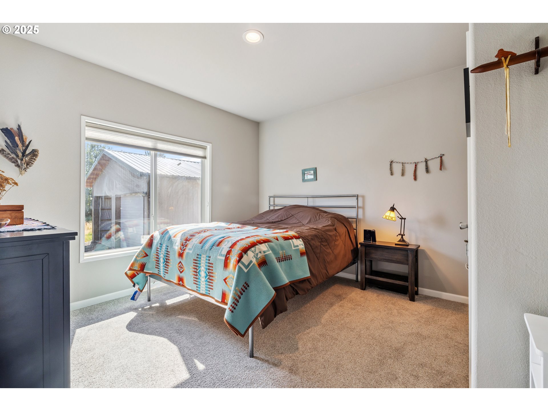 1682 Markham Road Hood River, OR 97031 - Photo 20 of 22 a bedroom with a bed and wooden floor