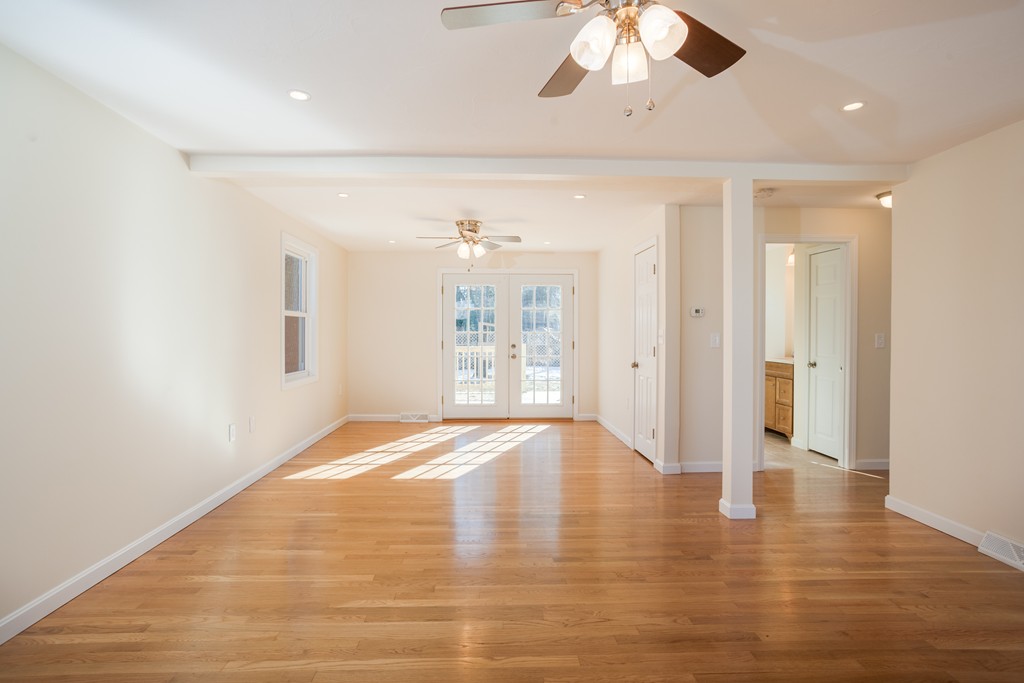 98 Indian Run Road Bellingham, MA 02019 - Photo 11 of 30 a view of an empty room with wooden floor and a window