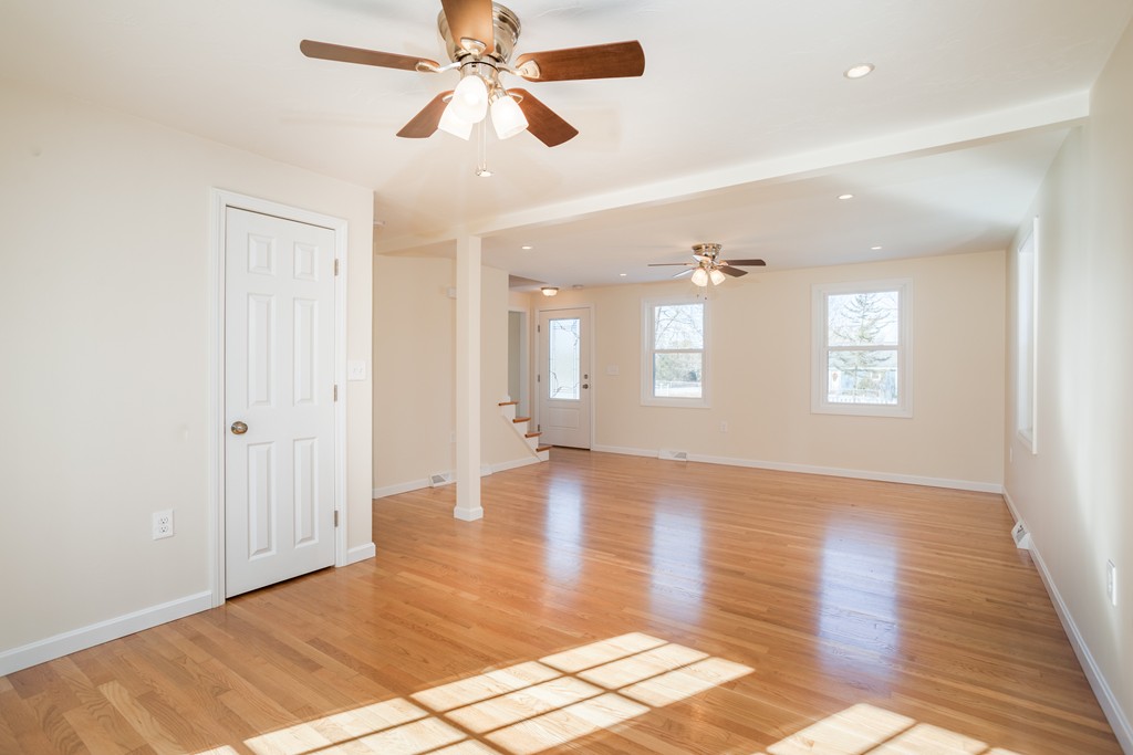 98 Indian Run Road Bellingham, MA 02019 - Photo 12 of 30 a view of an empty room with window and wooden floor