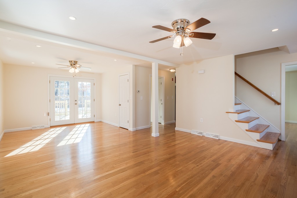 98 Indian Run Road Bellingham, MA 02019 - Photo 13 of 30 a view of an empty room with wooden floor and a ceiling fan
