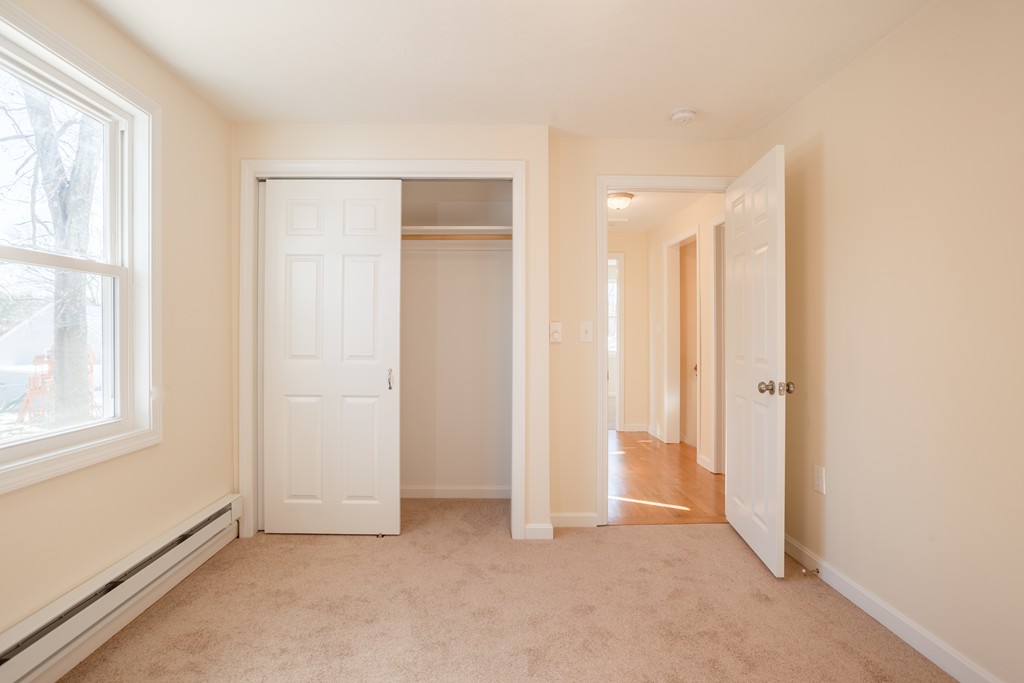 98 Indian Run Road Bellingham, MA 02019 - Photo 20 of 30 an empty room with windows and closet
