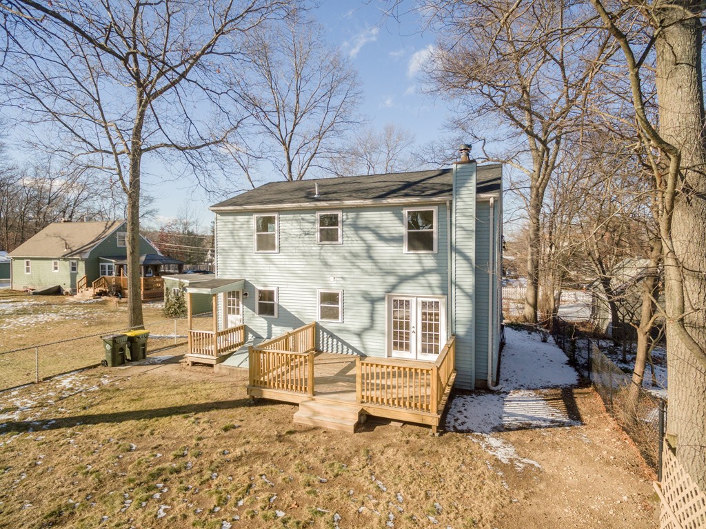 98 Indian Run Road Bellingham, MA 02019 - Photo 2 of 30 a view of a building with wooden bench and large trees
