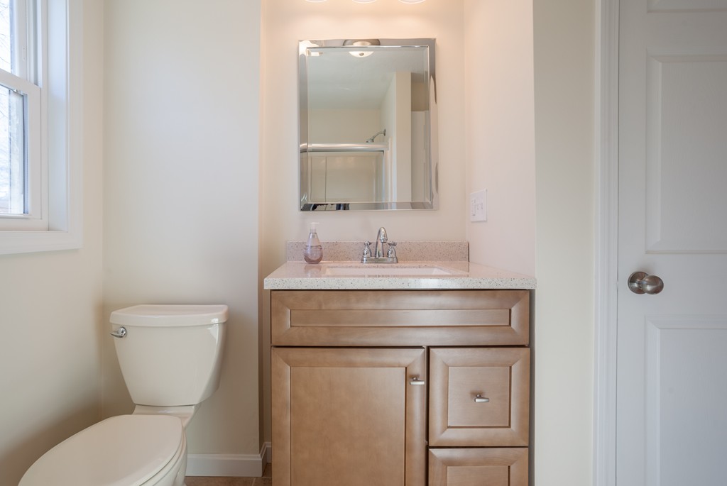 98 Indian Run Road Bellingham, MA 02019 - Photo 21 of 30 a bathroom with a toilet a sink and mirror