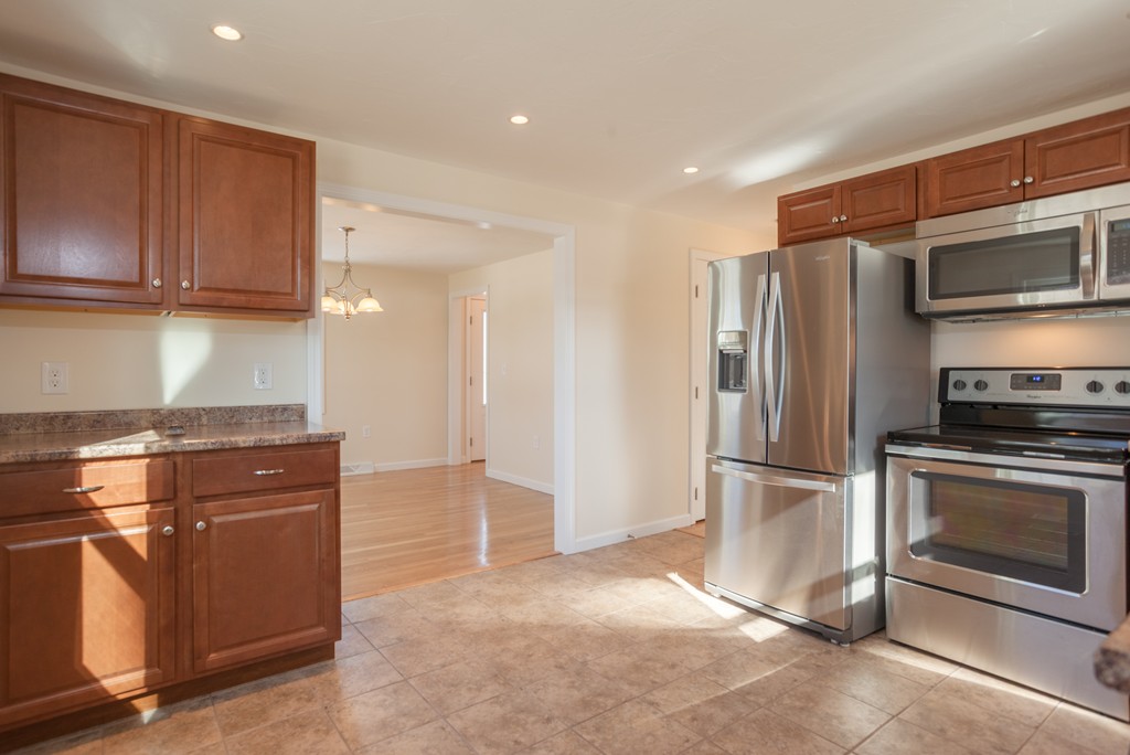 98 Indian Run Road Bellingham, MA 02019 - Photo 4 of 30 a kitchen with stainless steel appliances granite countertop a refrigerator and a stove