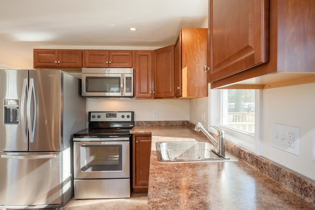 98 Indian Run Road Bellingham, MA 02019 - Photo 5 of 30 a kitchen with a refrigerator stove and microwave