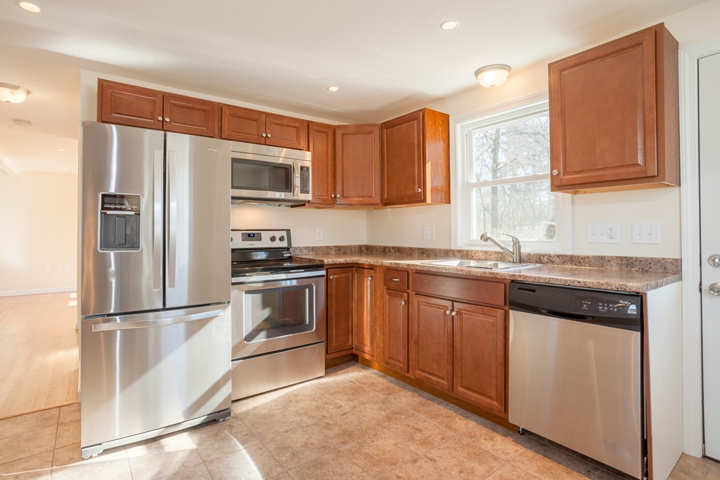 98 Indian Run Road Bellingham, MA 02019 - Photo 6 of 30 a kitchen with granite countertop stainless steel appliances a refrigerator and a sink
