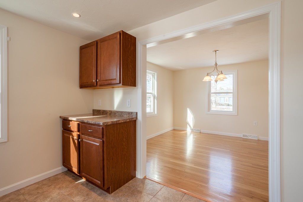 98 Indian Run Road Bellingham, MA 02019 - Photo 8 of 30 a kitchen with stainless steel appliances granite countertop a stove and a wooden cabinets