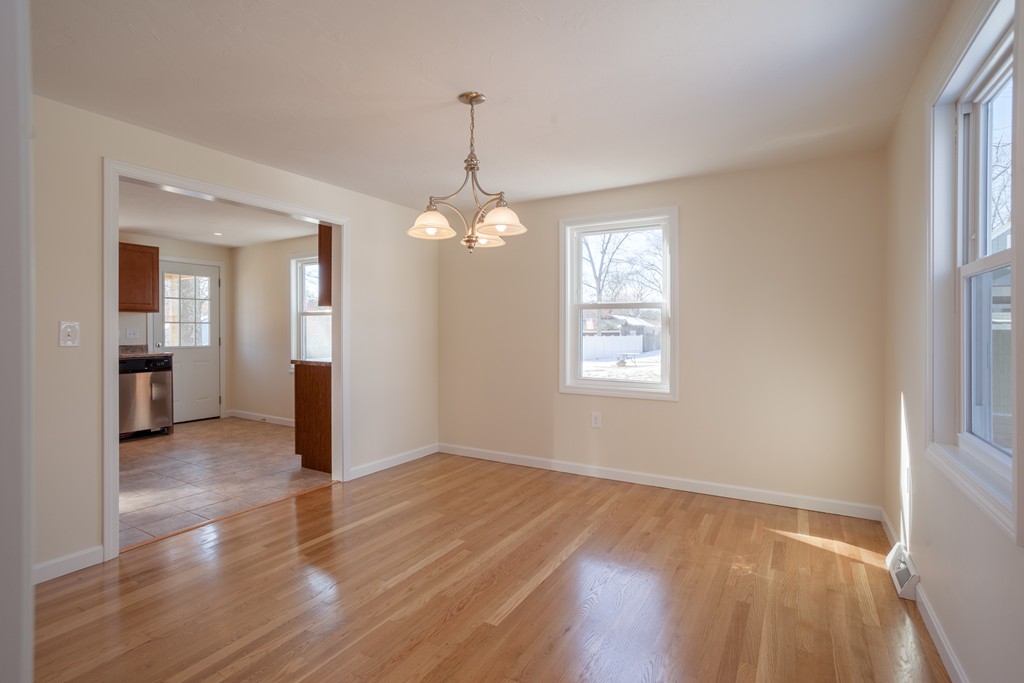 98 Indian Run Road Bellingham, MA 02019 - Photo 9 of 30 wooden floor in an empty room with a window