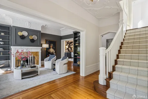 a living room with furniture a fireplace and a floor to ceiling window